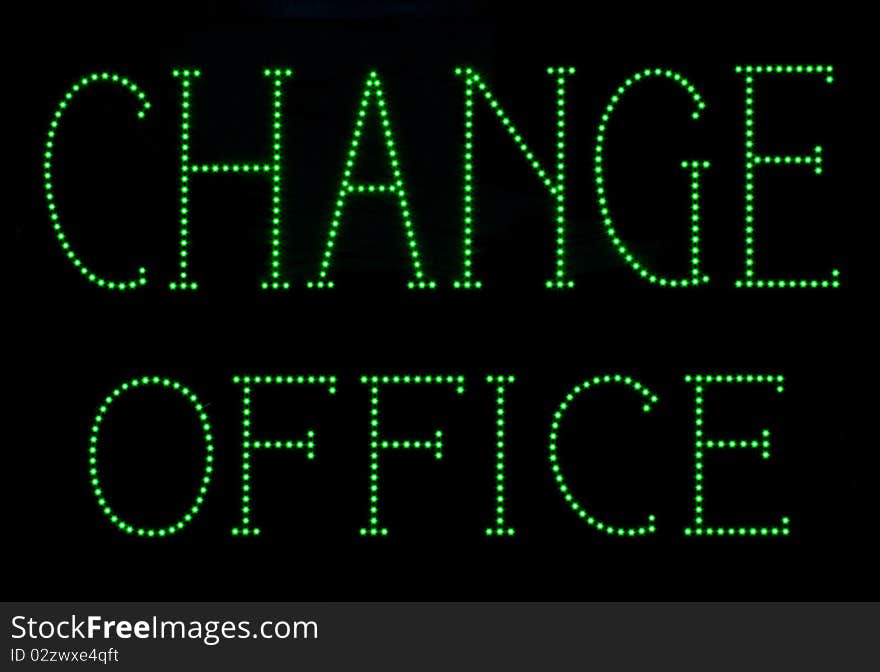 Green light, neon, currency exchange, signage. Green light, neon, currency exchange, signage