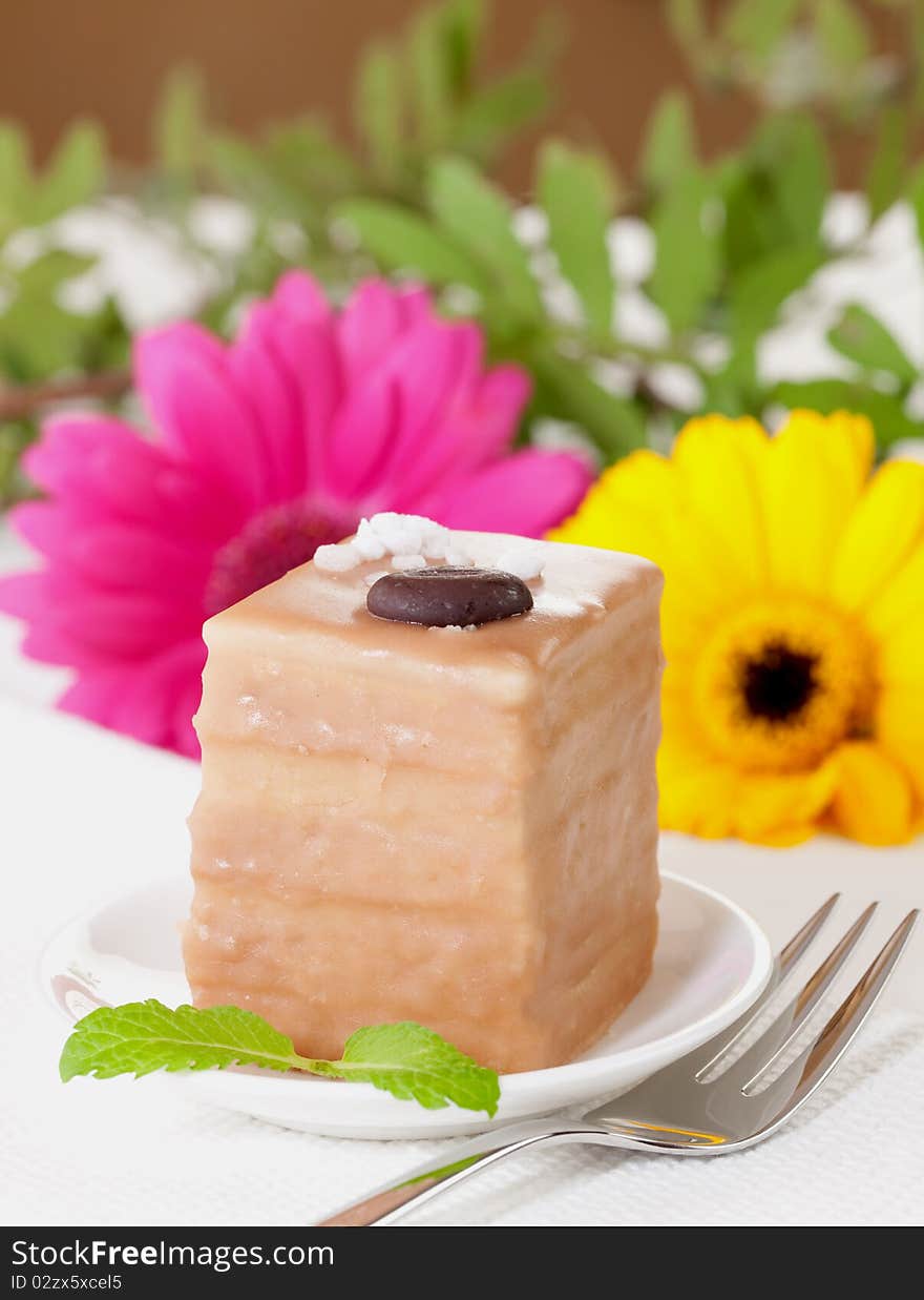 Petit four with chocolate and coffee cream. Petit four with chocolate and coffee cream