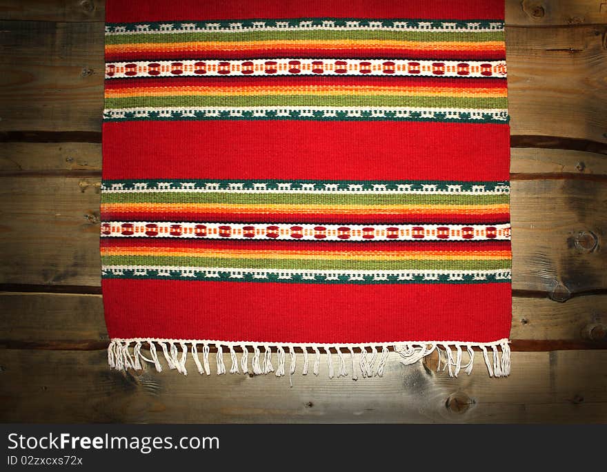 The textile traditional mat on wood backdrop