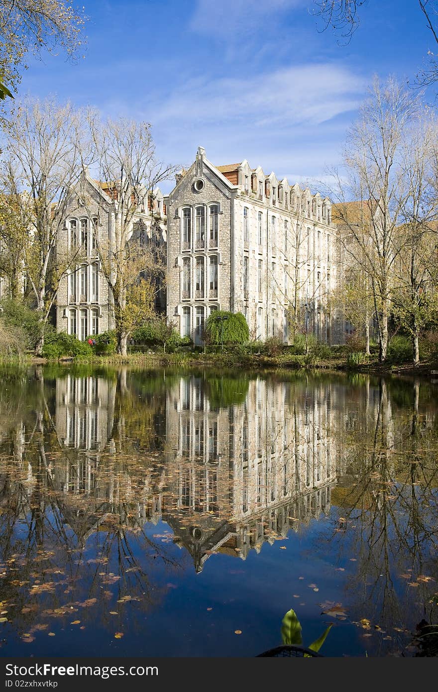 The old military headquarters and high school college building reflected over the lake at Parque D. Carlos I, in Caldas da Rainha, Silver Coast, Portugal. The old military headquarters and high school college building reflected over the lake at Parque D. Carlos I, in Caldas da Rainha, Silver Coast, Portugal