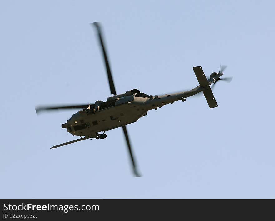 Modern military helicopter on a mission flying overhead