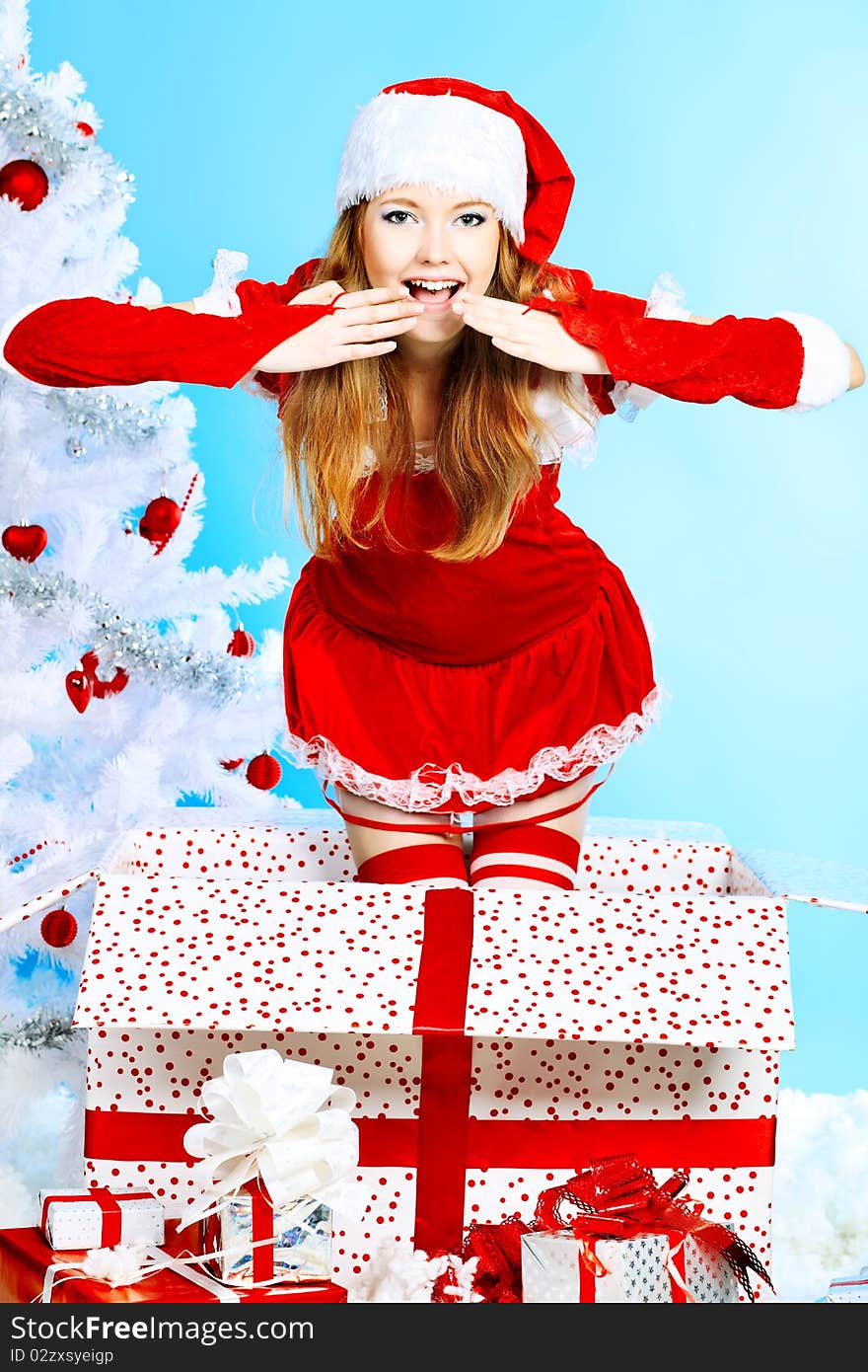 Beautiful young woman in Santa Claus clothes over Christmas background. Beautiful young woman in Santa Claus clothes over Christmas background.