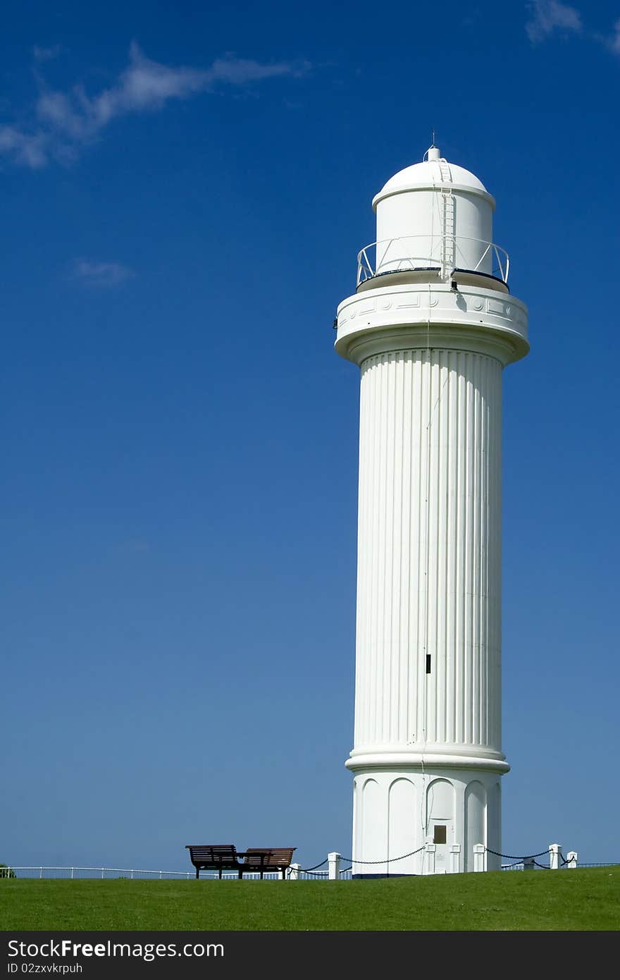 White light house under the clear blue sky. White light house under the clear blue sky