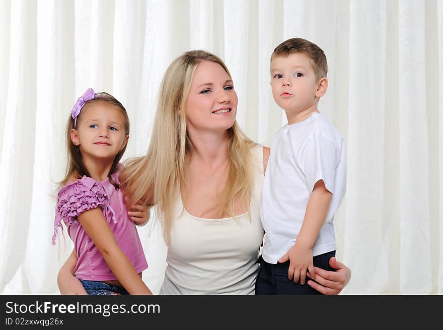 A young mother, her daughter and son having fun together