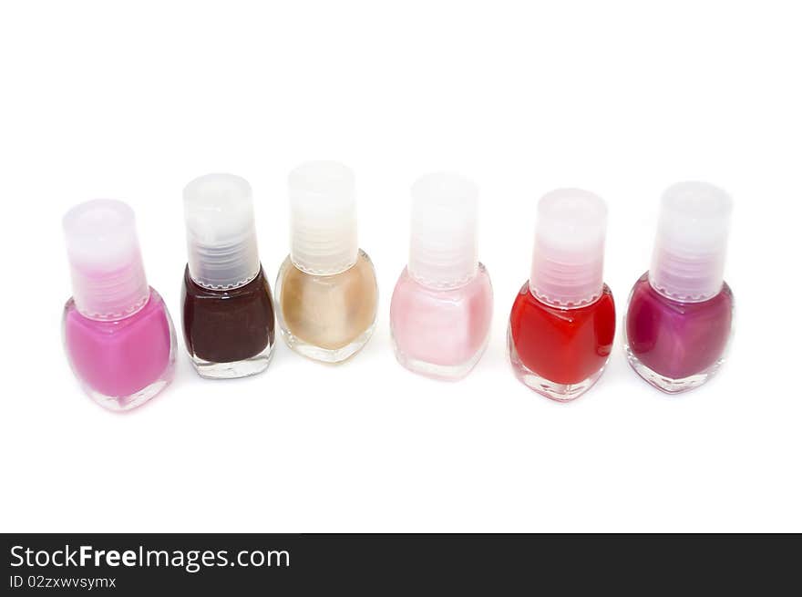 Six bottles of nail polish isolated on a white background