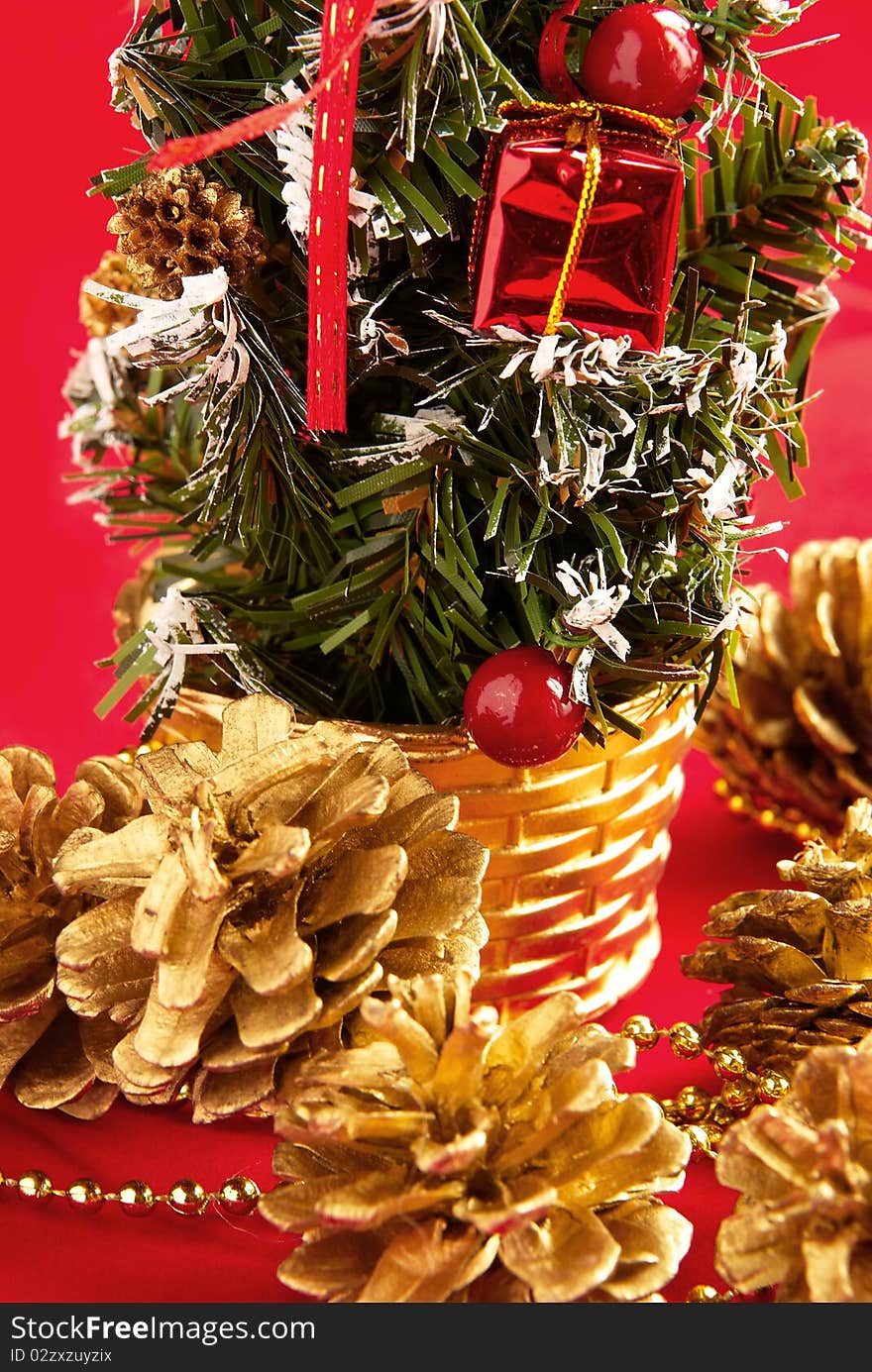 Decorative Christmas tree and cones with a gilt on a red background