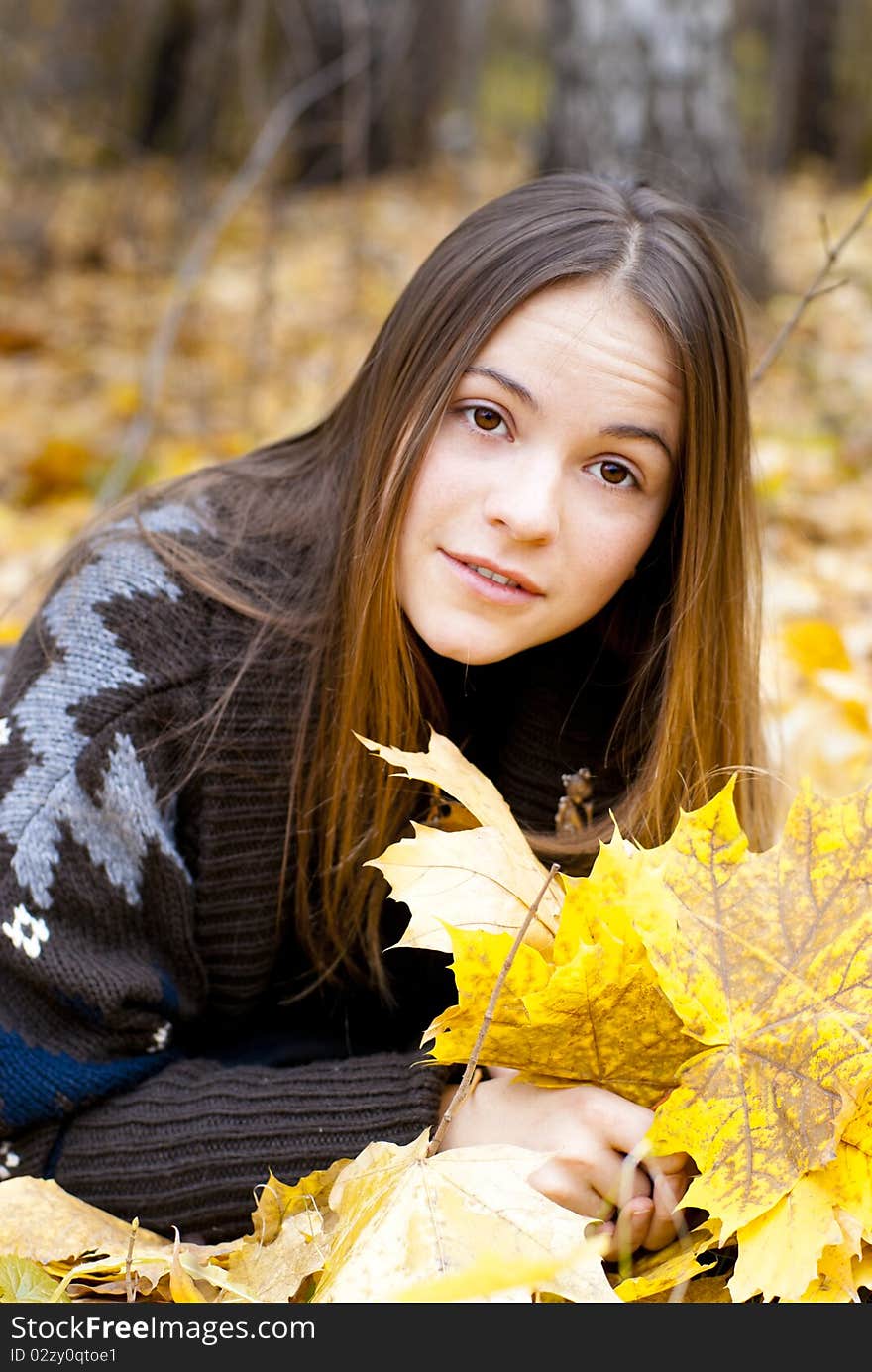 Portrait of amazed girl in autumn park laying on leaves. Portrait of amazed girl in autumn park laying on leaves.