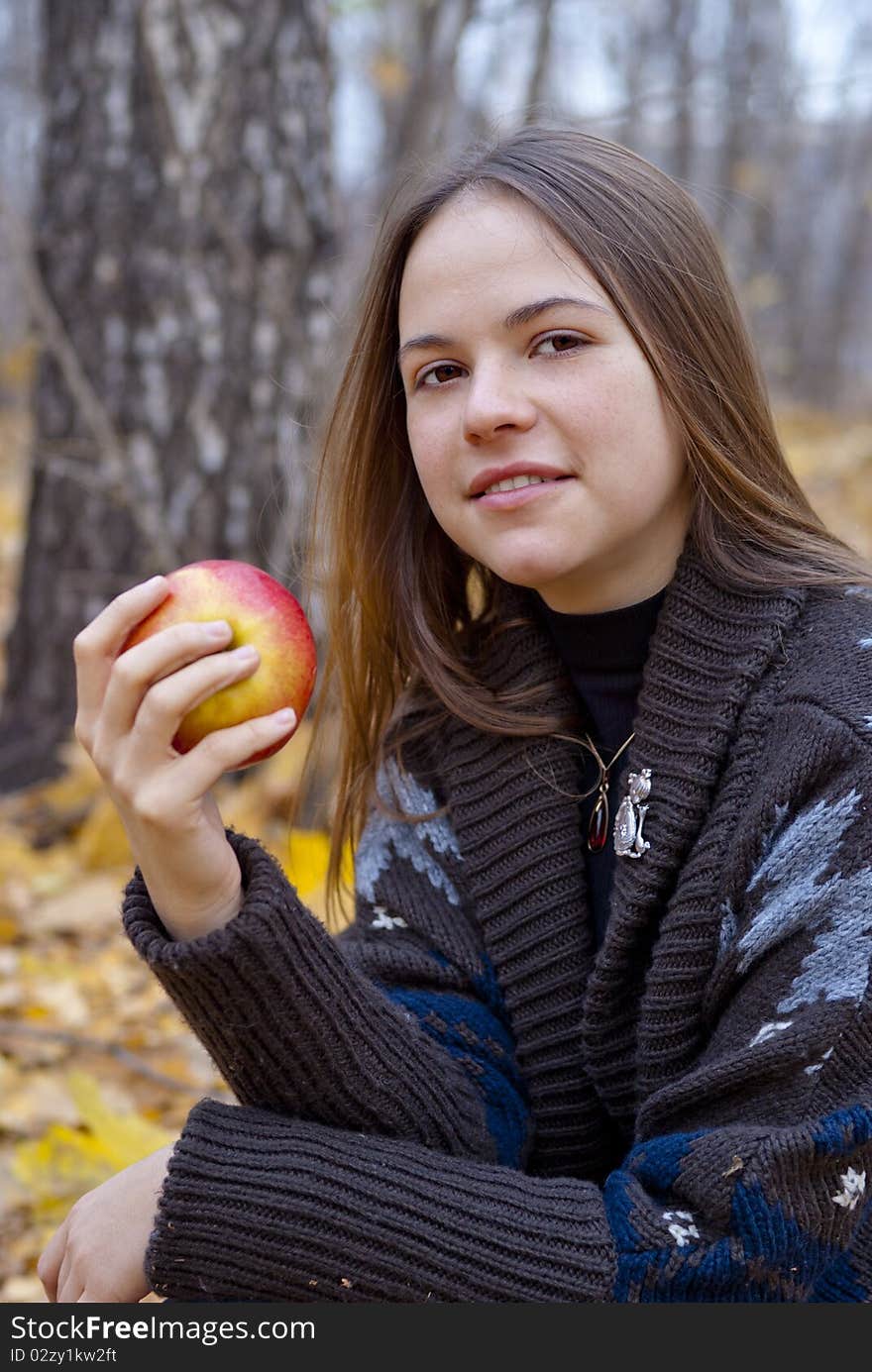 Portrait of brown-haired girl with apple