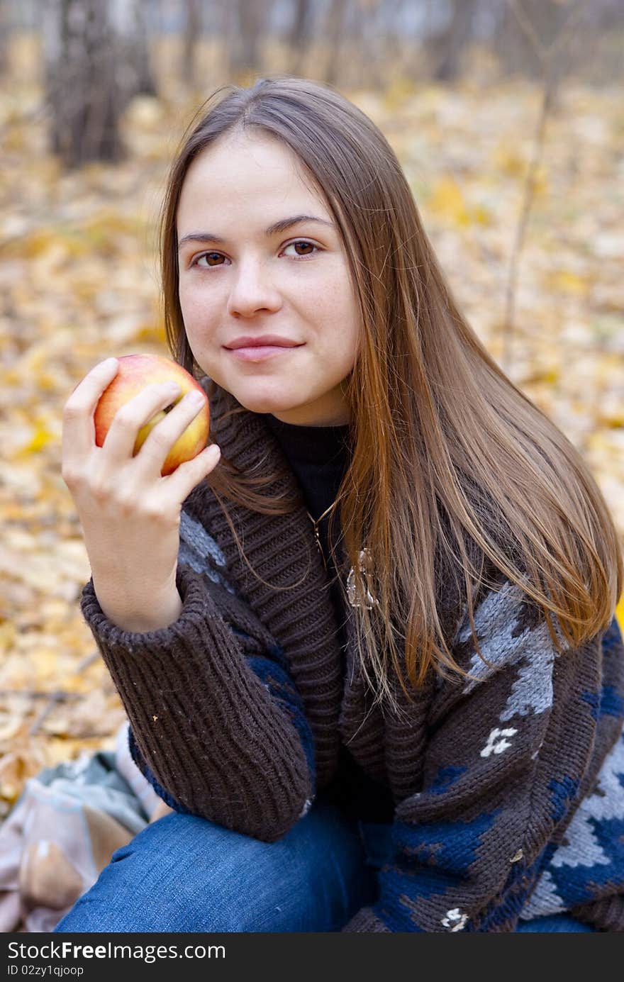 Portrait of brown-haired girl with apple