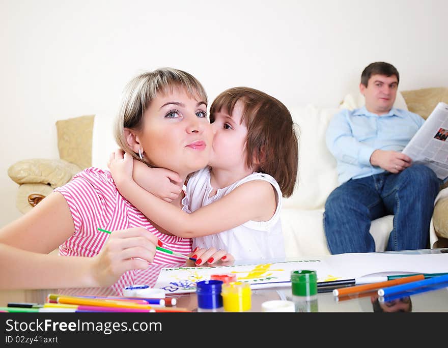 Mother and daughter together paint an album and have fun together.