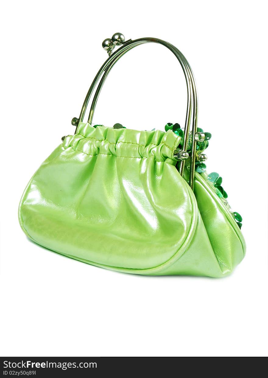 Green handbag with shiny items isolated on white