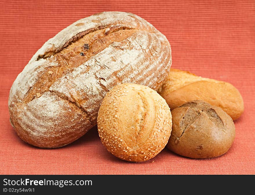 Group of fresh bread on a red background.