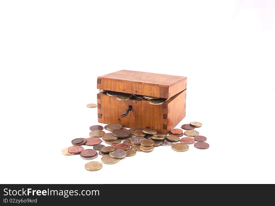 Antique handcrafted wooden money box with small money isolated on a white background