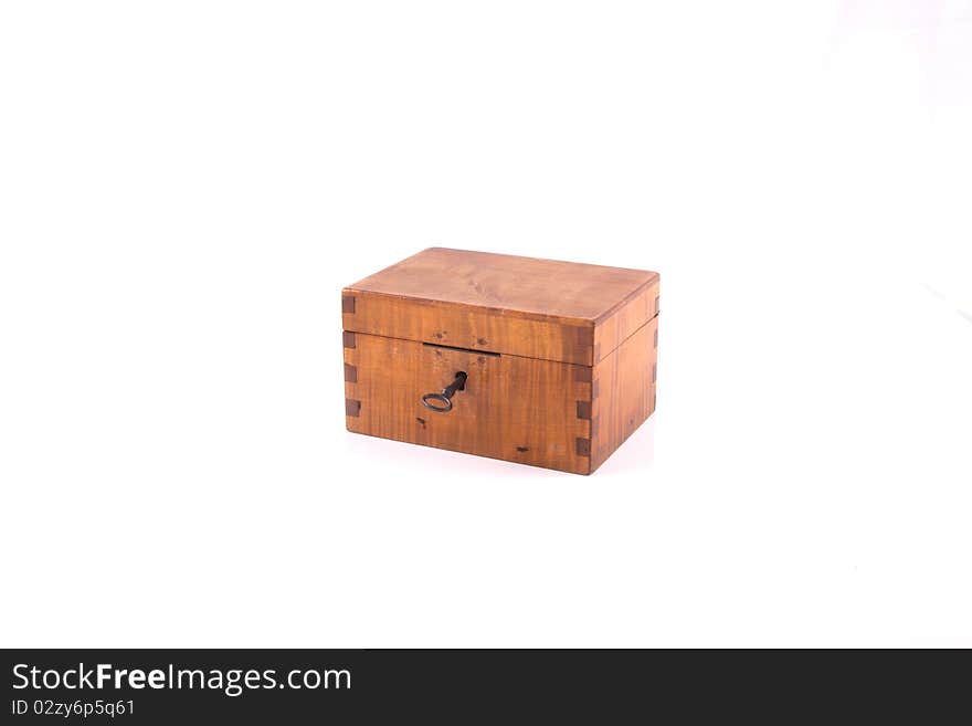 Antique handcrafted closed wooden money box with small money isolated on a white background