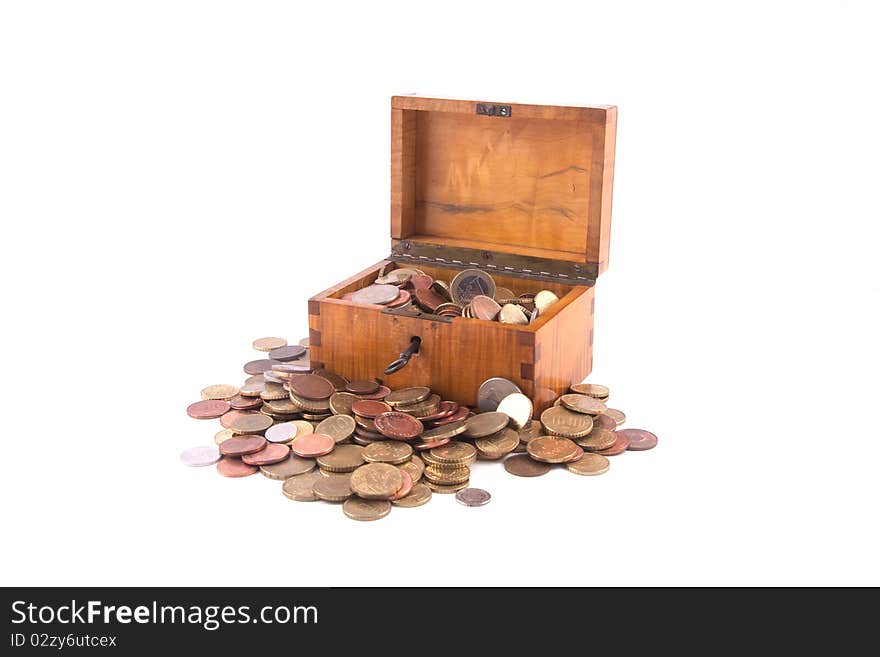 Antique handcrafted open wooden money box with a lot of small money isolated on a white background