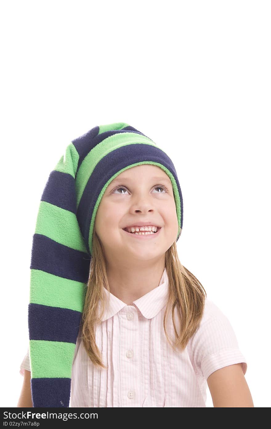 Girl in a green cap looking up and smiling on a white background. Girl in a green cap looking up and smiling on a white background