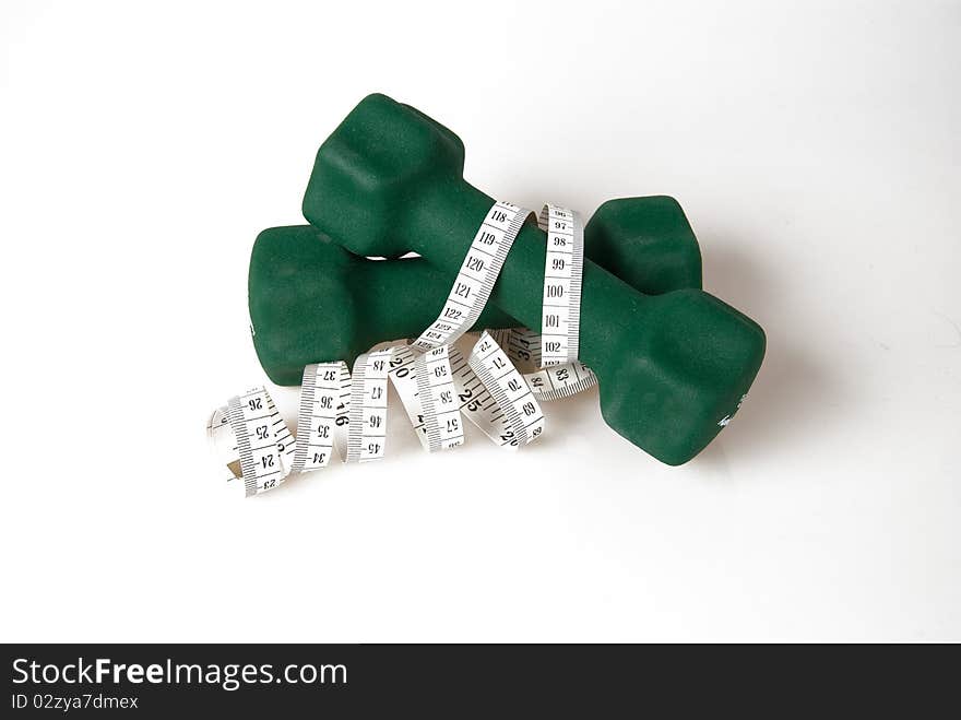 Green dumbbells wrapped with measure tape