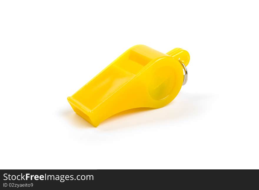 Yellow plastic whistle on a white background. Yellow plastic whistle on a white background.