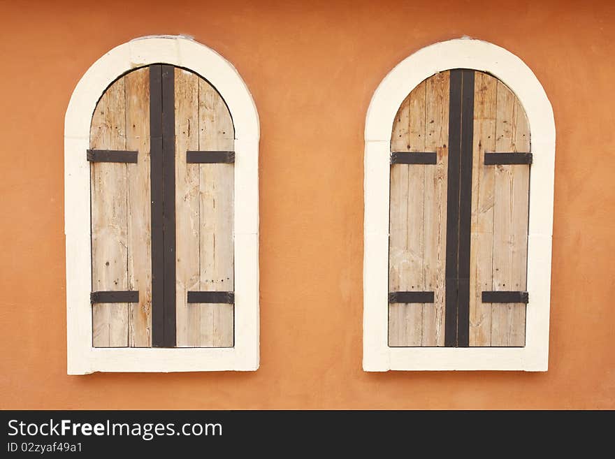 Plain European style windows design elements on orange wall. Plain European style windows design elements on orange wall