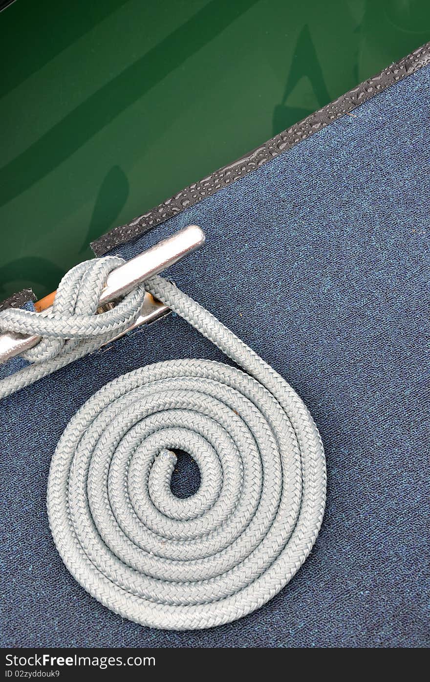 Rope or cable of boat twist on dock board, as a circle. Rope or cable of boat twist on dock board, as a circle.