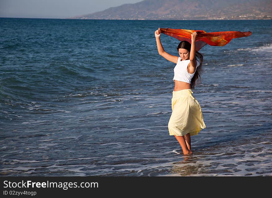 A woman with the pareo is on a coast