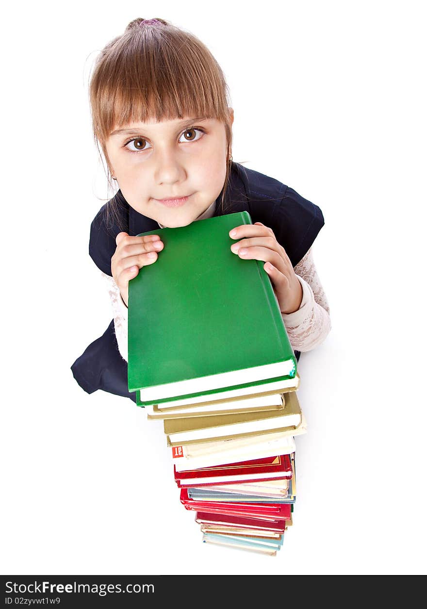 Schoolgirl with books is looking up. Isolated on white background