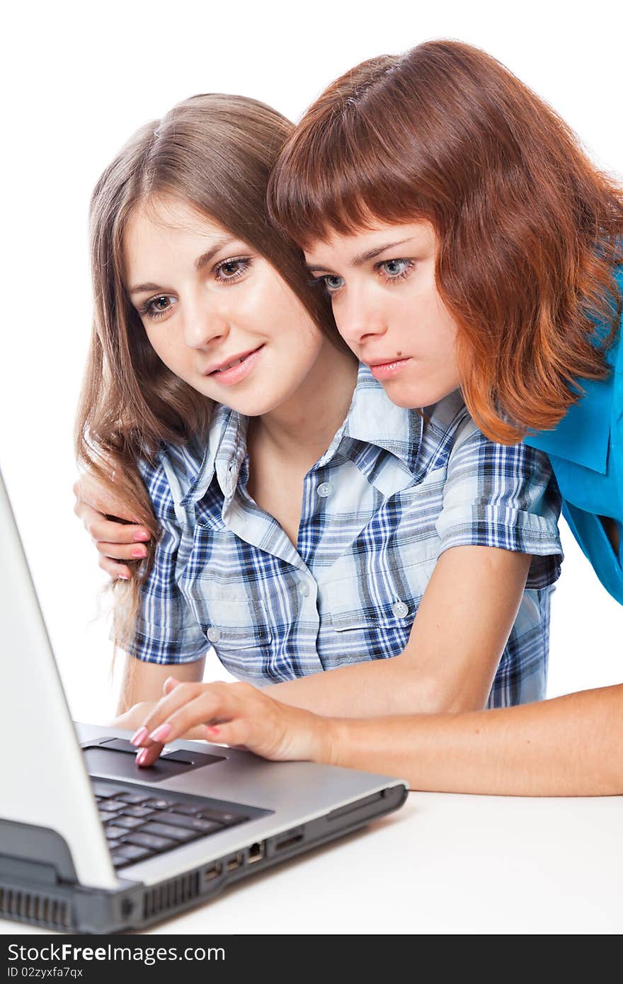 Two teen-girls with laptop. Isolated on white background