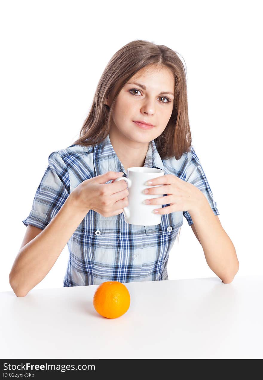 Teen-girl with cup of coffee and two oranges in hand. Isolated on white