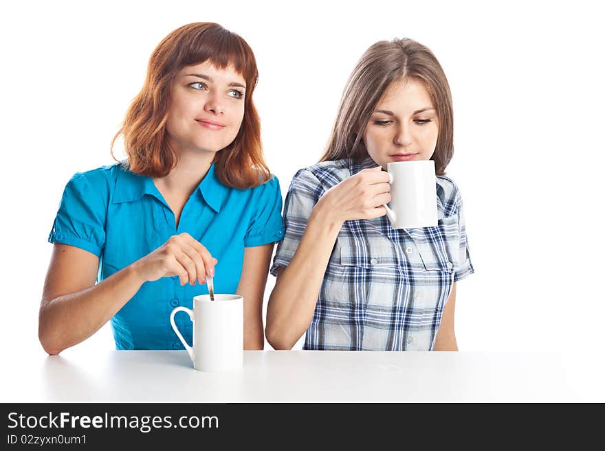 Two teen-girls are drinking tea