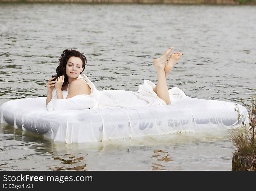 Woman lying on the bed in the sea