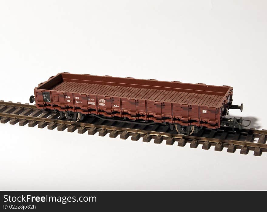 A platform wagon on rail isolated by white background