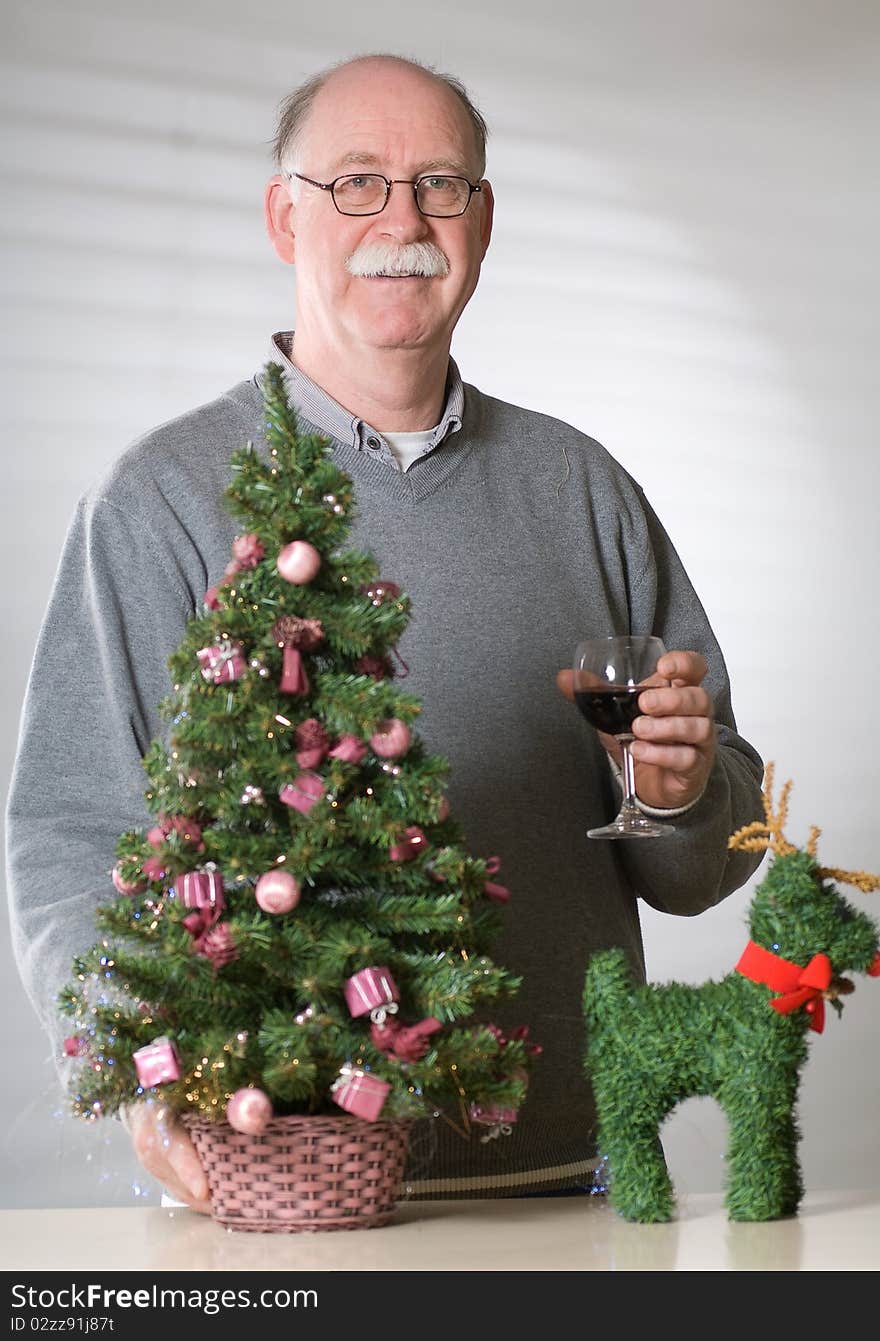 Senior man with christmas decoration on white