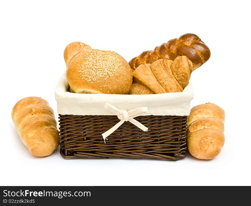 Fresh baked rolls in a basket on white. Fresh baked rolls in a basket on white