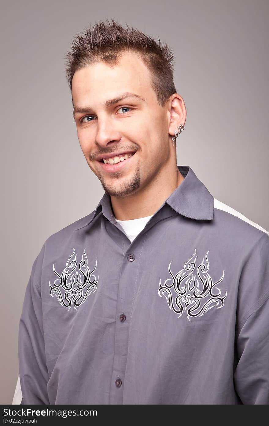 Portrait of smiling handsome man on gray background. Portrait of smiling handsome man on gray background