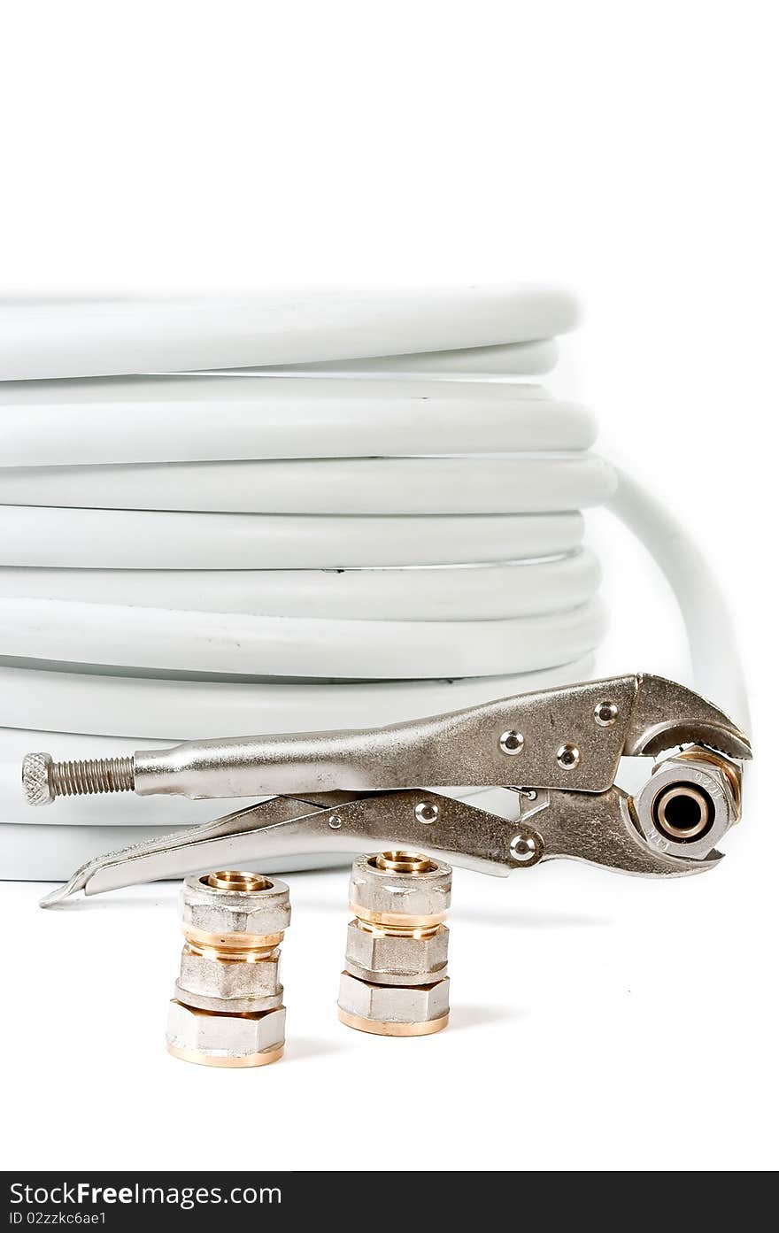 Pipe and adjustable spanner on a white background close up