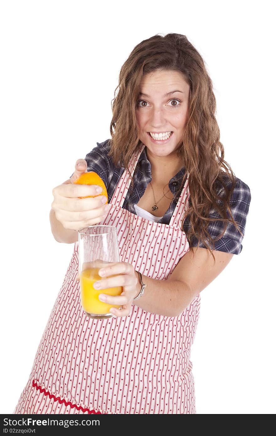 A woman is squeezing orange juice into a glass. A woman is squeezing orange juice into a glass.