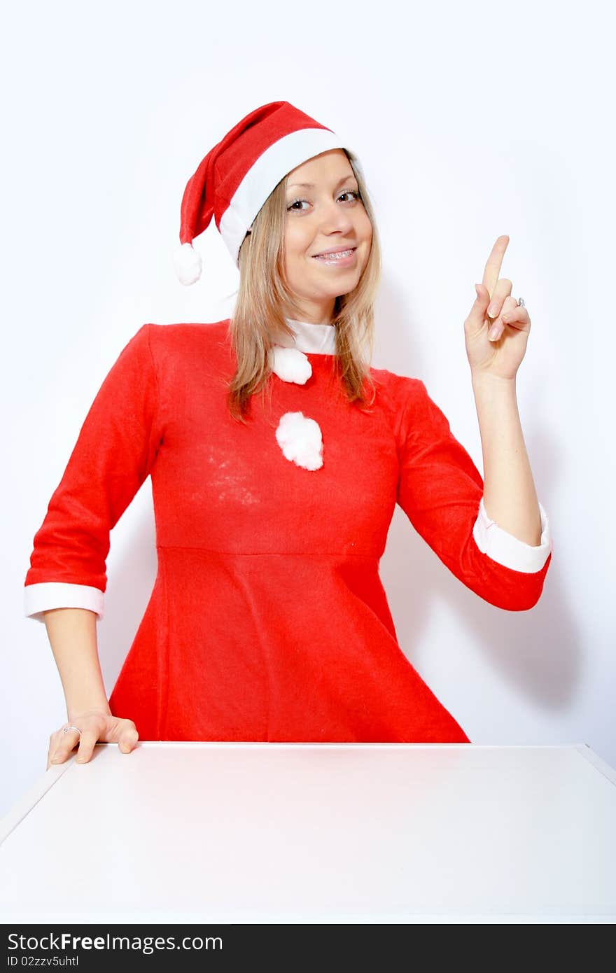 Beautiful young smiling girl in Santa red hat