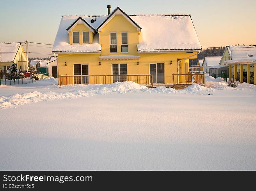 Country house in pink sunset light in winter. Country house in pink sunset light in winter