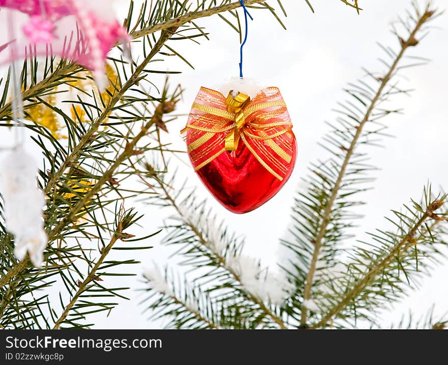 Christmas-tree decoration (red heart) on the tree outdoor