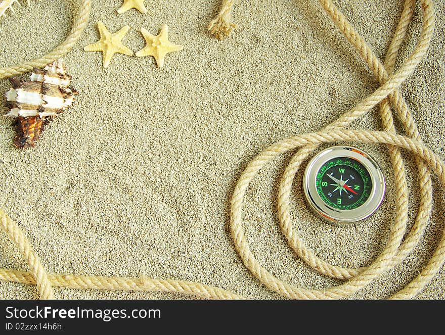 Starfish and shells in rope on sand