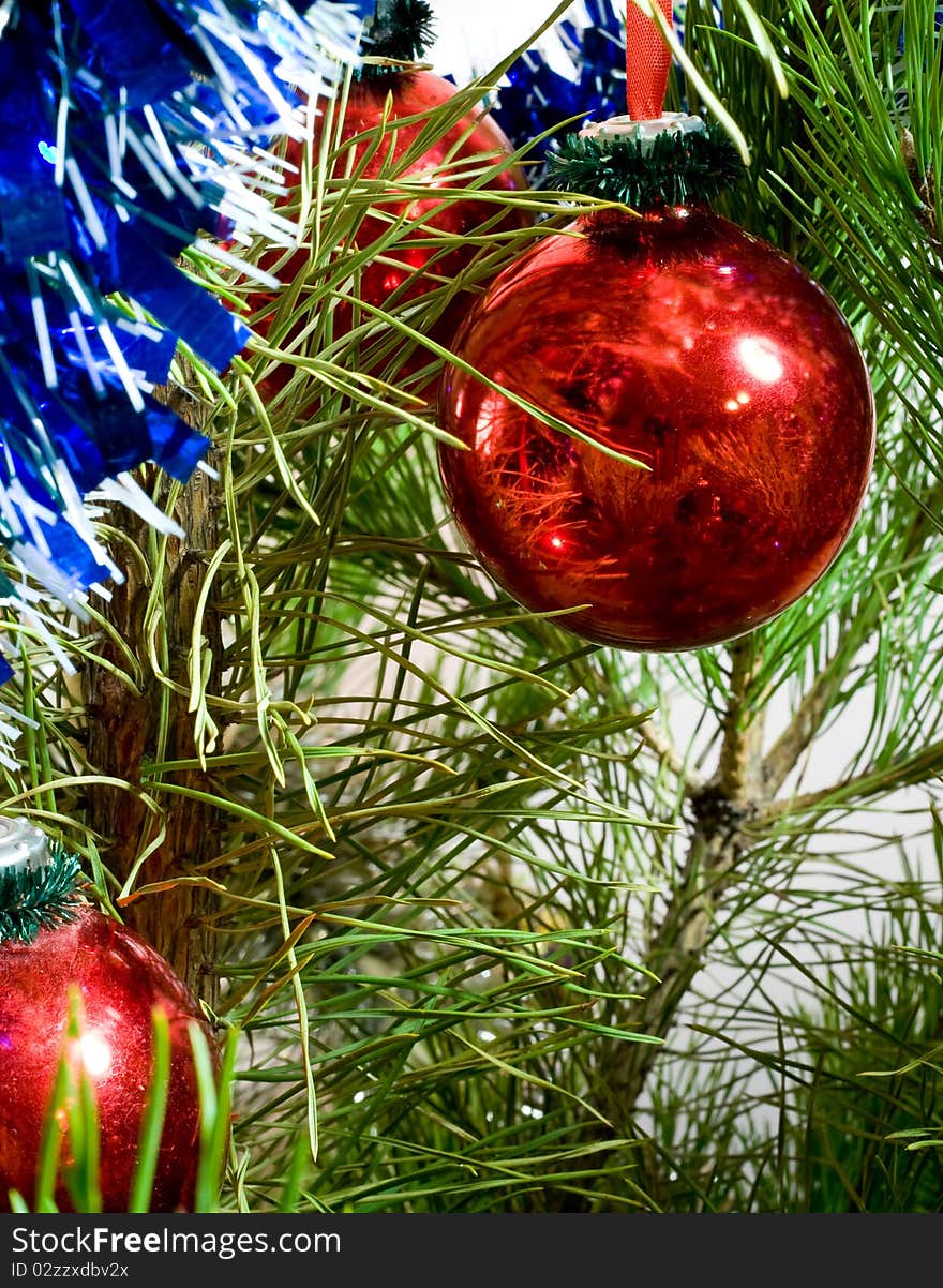 Red glass balls and tinsel on Christmas-tree. Red glass balls and tinsel on Christmas-tree