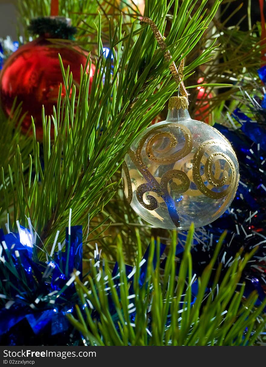 Two glass balls and tinsel on Christmas-tree. Two glass balls and tinsel on Christmas-tree