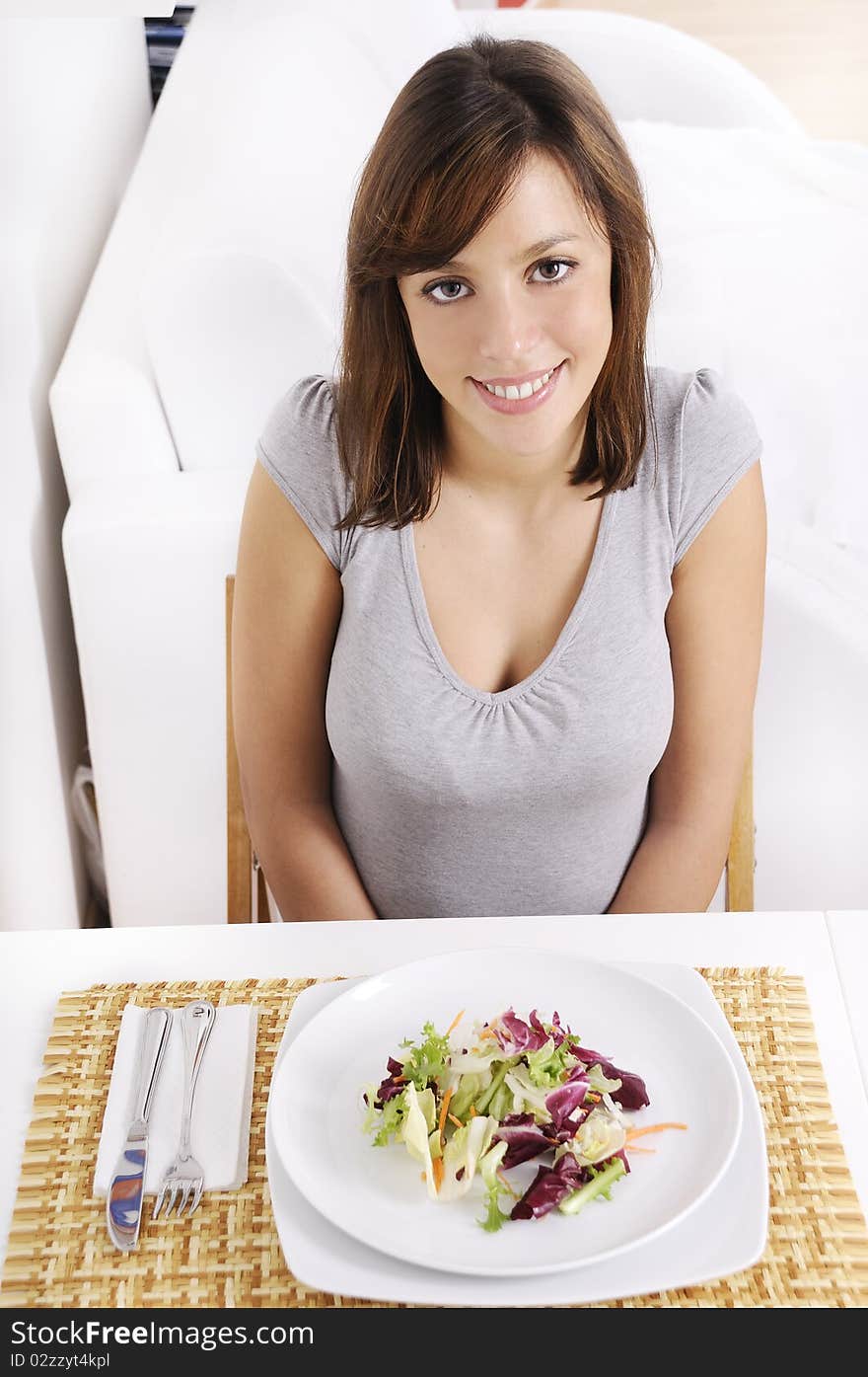 Young woman eating salad