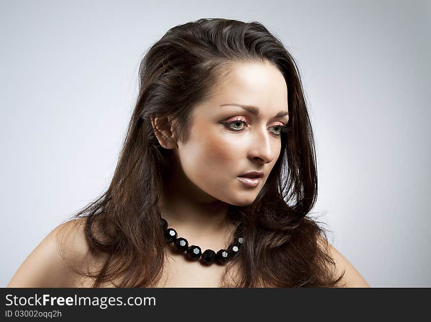 Studio photo of beautiful woman, cute brunette, gray background. Studio photo of beautiful woman, cute brunette, gray background