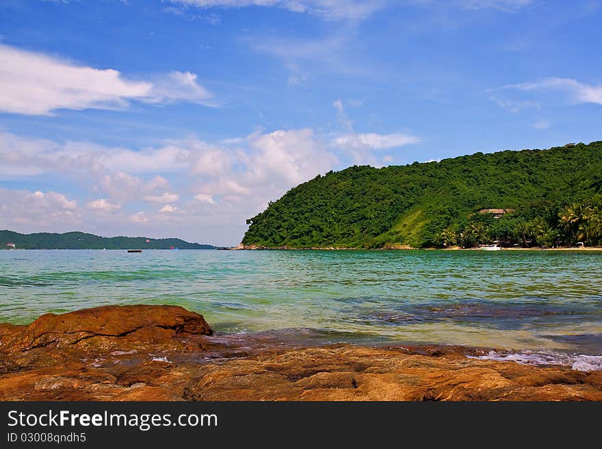 Sea with rock in foreground and island on far. Sea with rock in foreground and island on far