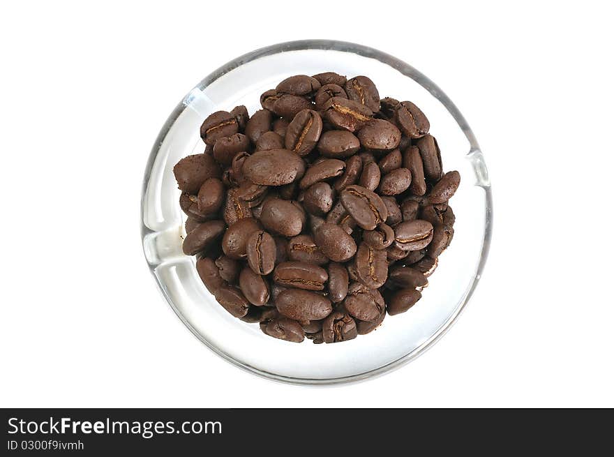 Coffee beans lying over the glass dish