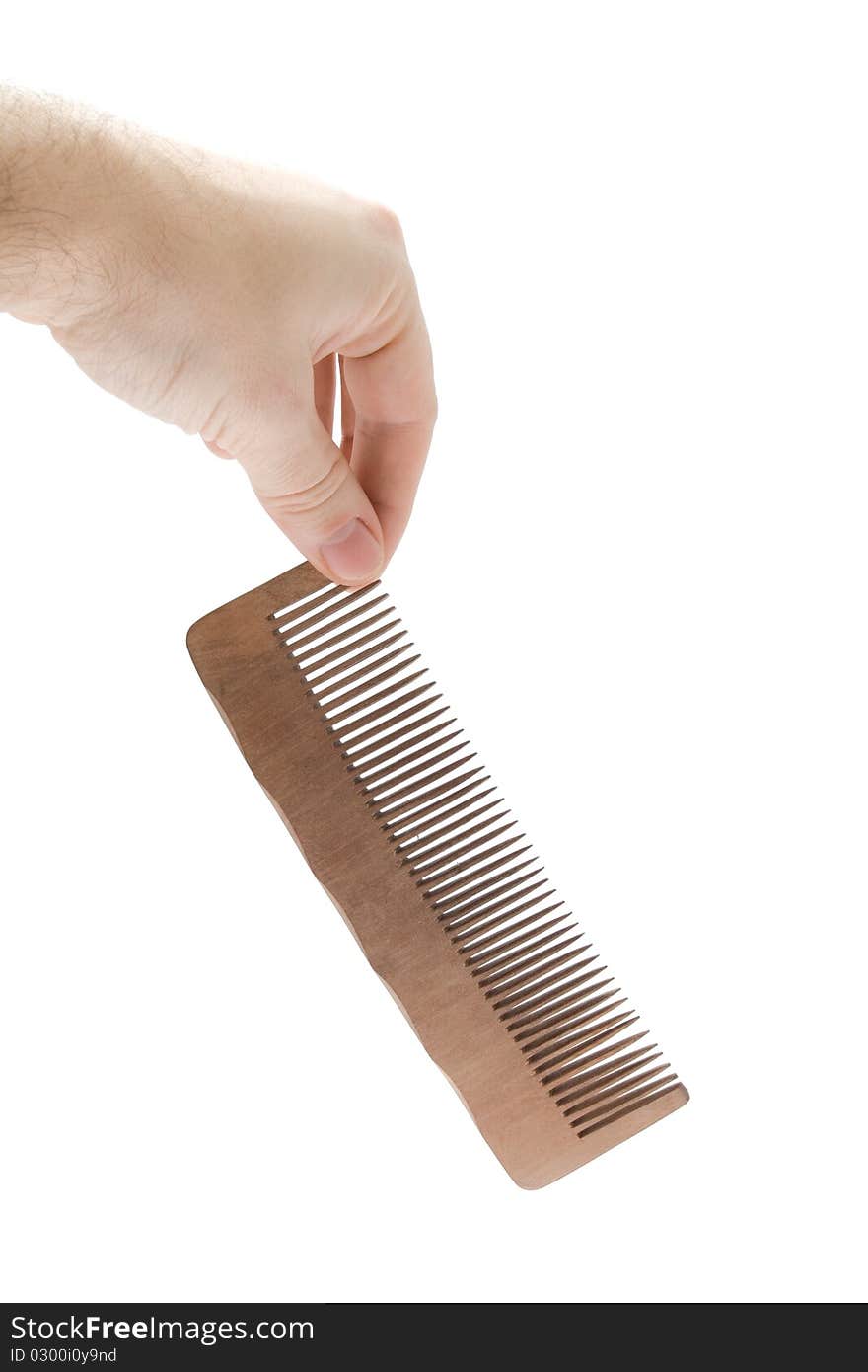 Comb in hand on white background