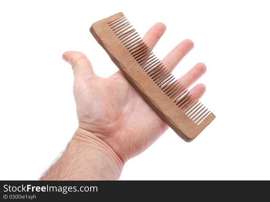 Comb in hand on white background