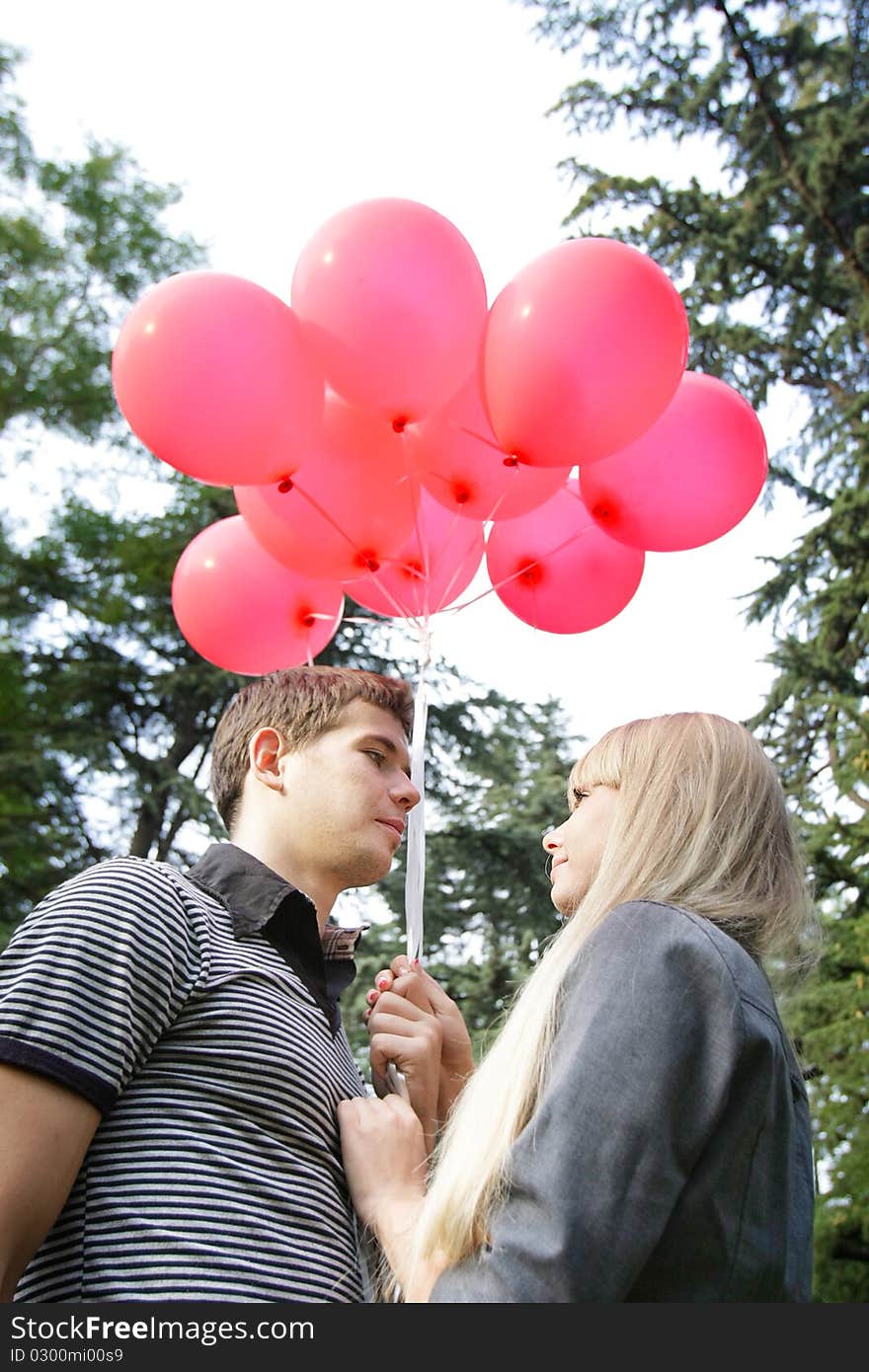 Young loving couple with red balloons. Young loving couple with red balloons