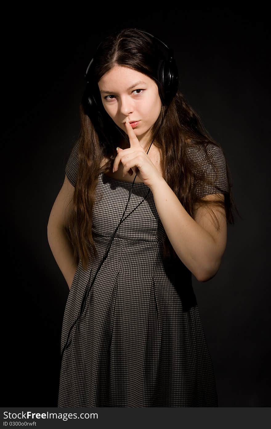 Young beauty girl in headphones listening music